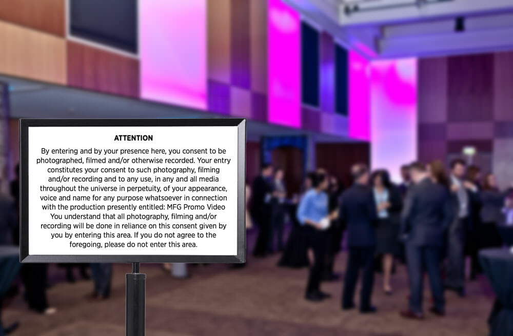 An image of a conference with an attention signage for attendees.