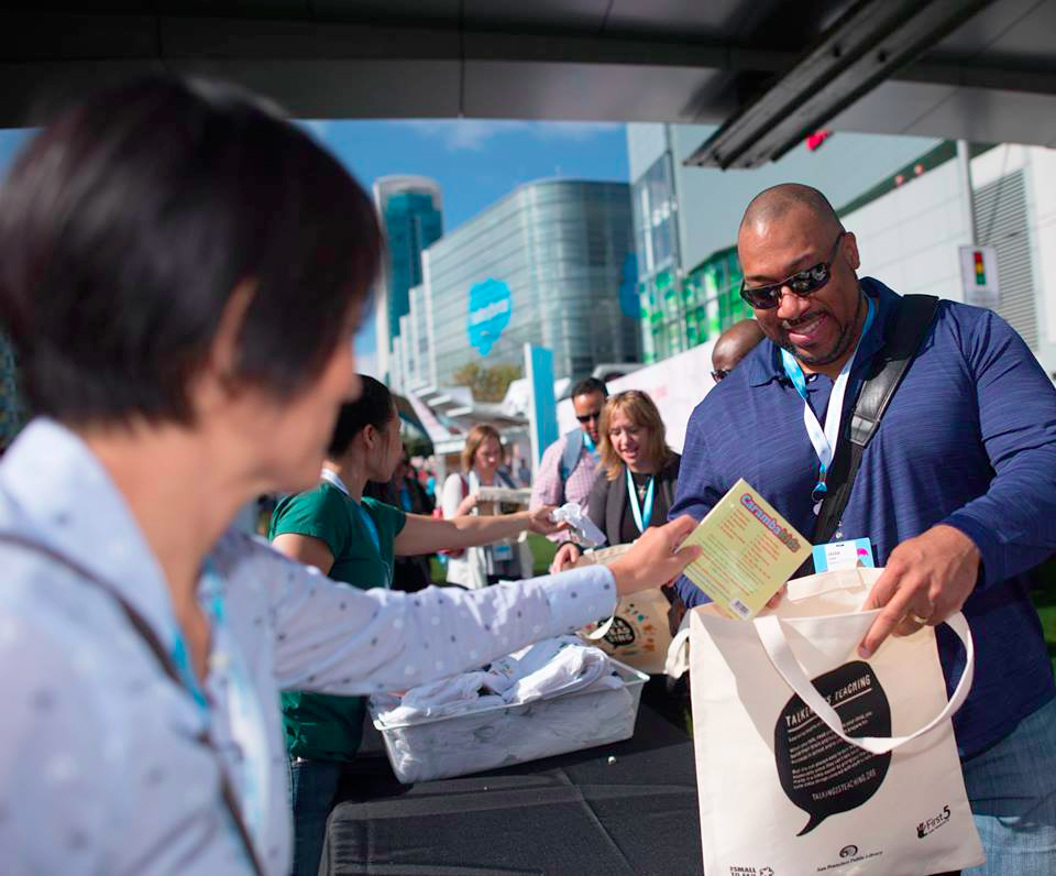 Dreamforce volunteers assembling early STEM education kits.