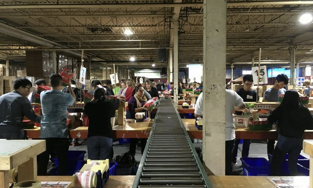 Volunteers packing shoeboxes