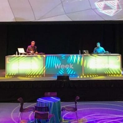 Speakers on stage at the Biotech Boston conference, a hybrid event