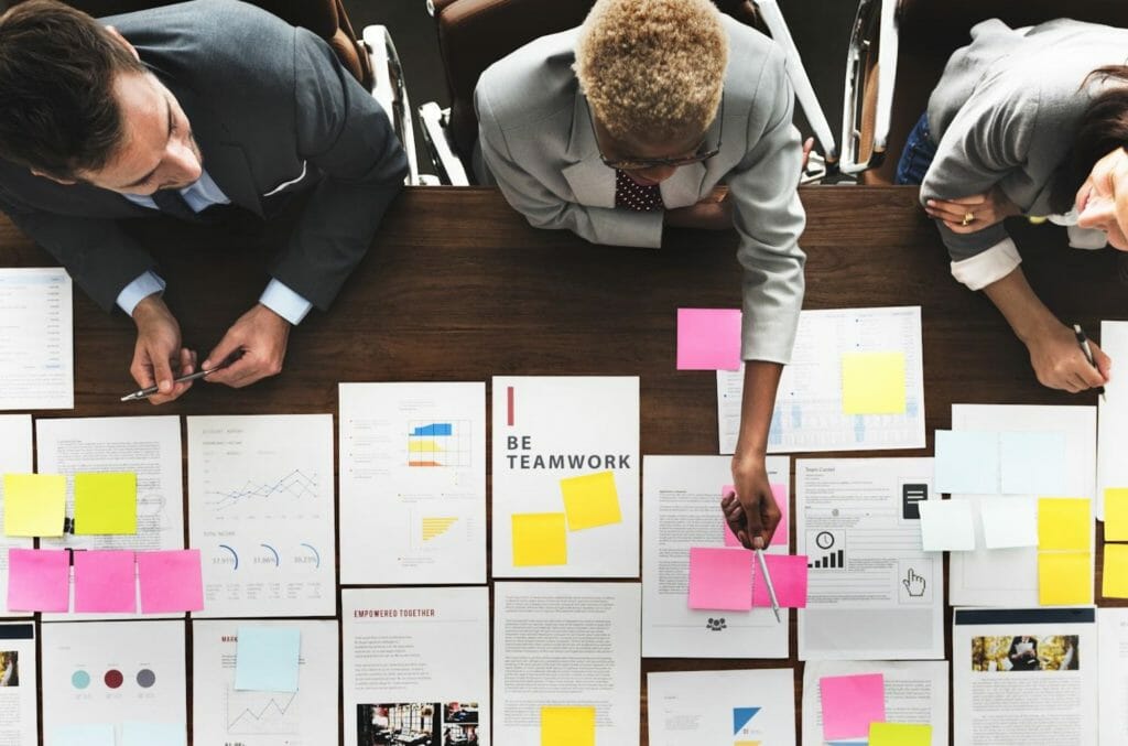 A group of event professionals planning an event together on a table.