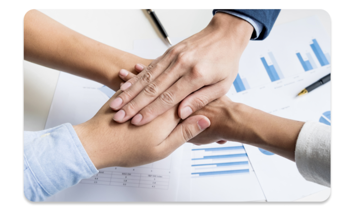 Four hands on top of each other, visualizing teamwork