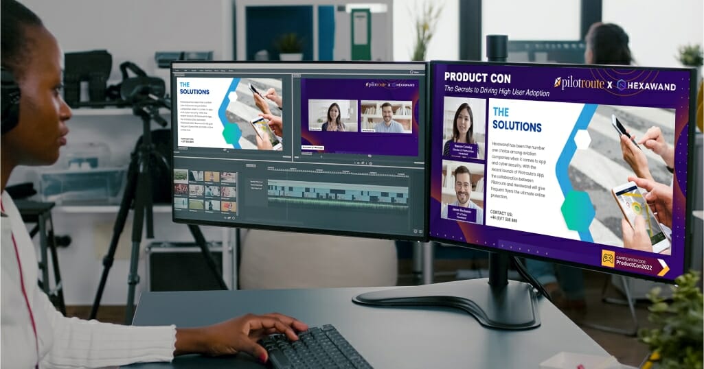 A woman editing a video using two monitors