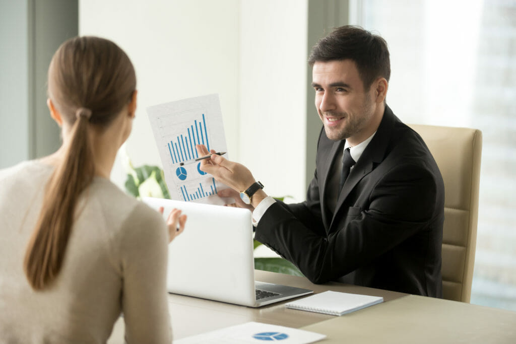 Happy event manager holds financial report, shows earnings on sponsorships.