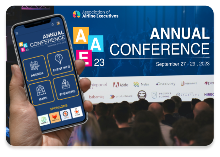 Event stage with massive screen showing “Annual Conference” Event Space visuals. A crowd of attendees is in front of it. In the foreground, a hand holds up an iPhone with mobile event app matching the visuals on the big screen. It has options for Agenda, Event Info, Maps, Speakers, and Sponsors.