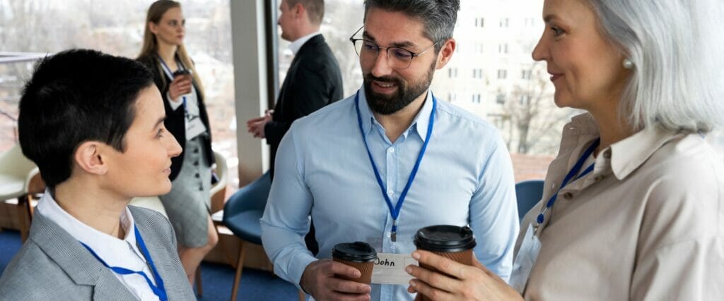 A small group of event attendees are smiling and talking at an experiential event.