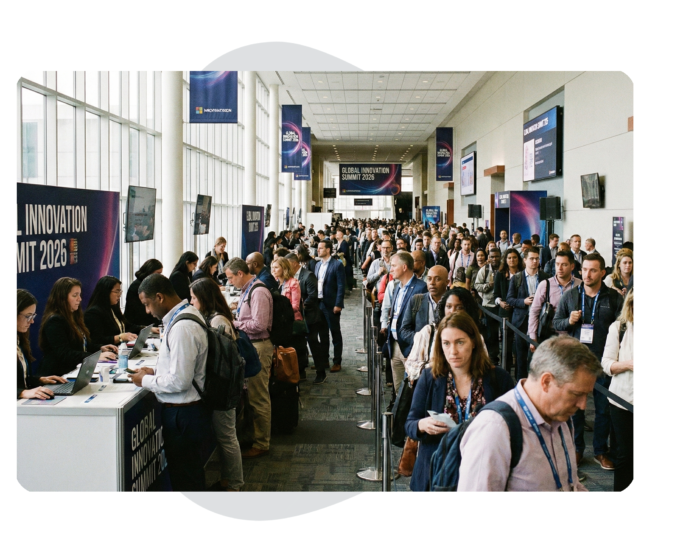 Long line of attendees waiting to check in at a registration desk