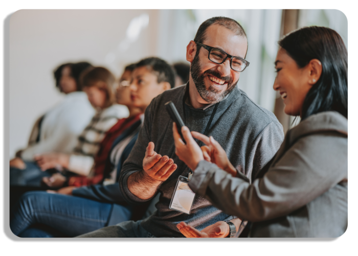 Happy attendees smiling and networking at an event conference
