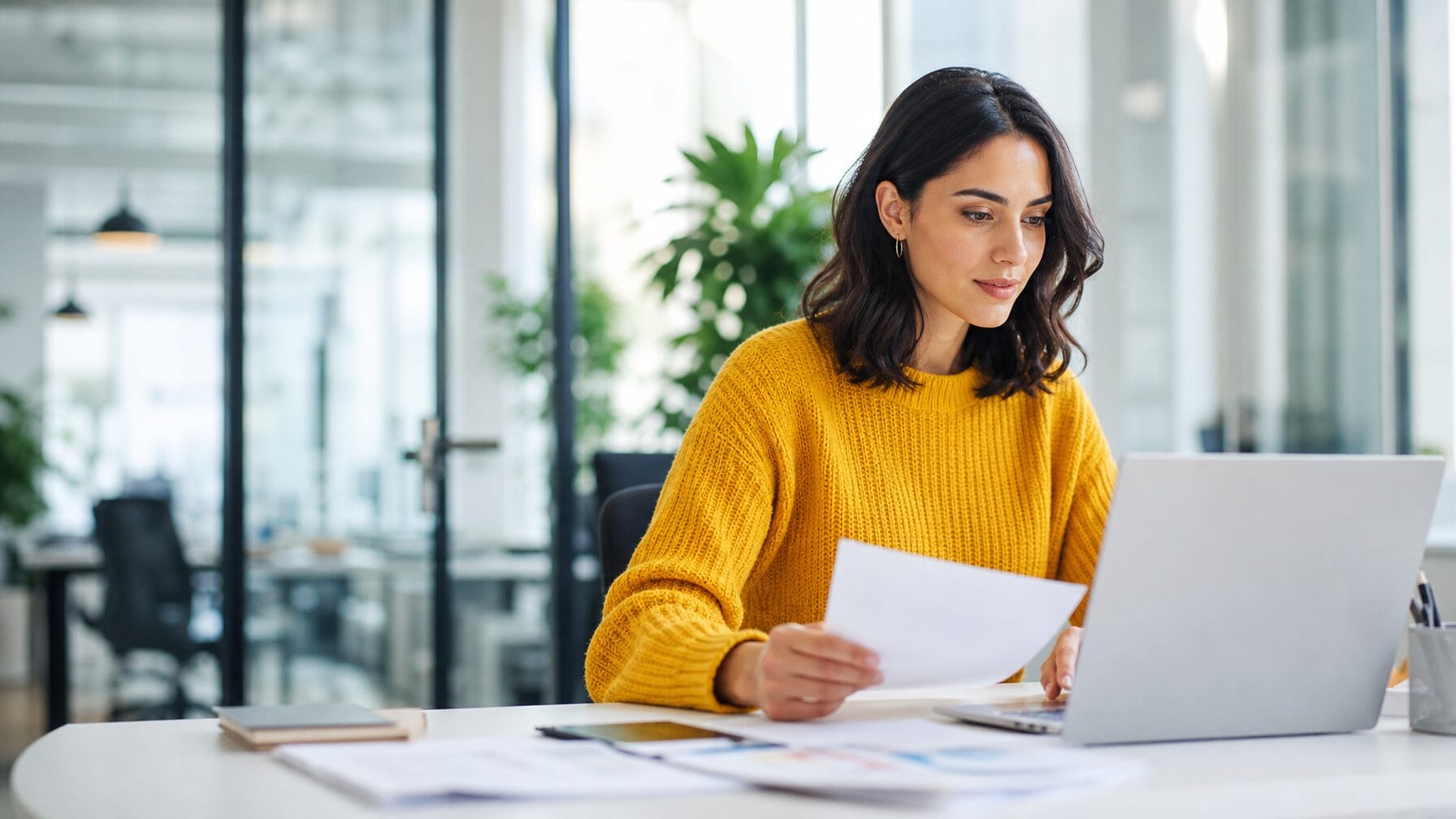 An event organizer uploading documents to configure their AI registration concierge, working productively at a modern desk